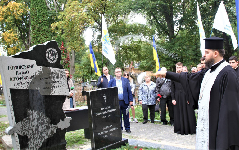 Отець Агапіт освячує пам'ятник Горянському. За ним видно присутніх учасників події.